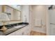 Elegant bathroom showcasing a marble countertop, gold-framed mirror and modern fixtures at 4060 Penshurst Park, Sarasota, FL 34235