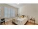 Comfortable bedroom featuring wood floor, window with shutters and stylish bedding at 4060 Penshurst Park, Sarasota, FL 34235
