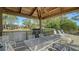 Covered deck with seating overlooking a pond, providing a serene outdoor space at 4060 Penshurst Park, Sarasota, FL 34235