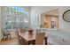 Dining Room boasts vaulted ceiling, a large window with shutters, and a pass-through to the adjacent kitchen at 4060 Penshurst Park, Sarasota, FL 34235
