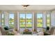 Living room with natural light, plantation shutters, overlooking a lake and golf course at 4060 Penshurst Park, Sarasota, FL 34235