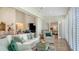 Bright and airy living room with french doors, neutral colors, and views into the bedroom at 4060 Penshurst Park, Sarasota, FL 34235