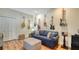 Cozy living room with a blue sofa, ottoman and hardwood floors, accented with guitars at 4060 Penshurst Park, Sarasota, FL 34235