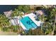 Beautiful outdoor pool with crystal-clear water, surrounded by lush landscaping and lounge chairs, perfect for relaxation at 4060 Penshurst Park, Sarasota, FL 34235