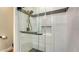 Modern shower featuring white subway tile, a glass door, and black hardware accents at 4060 Penshurst Park, Sarasota, FL 34235