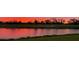 Picturesque view of the golf course and lake at sunset, creating a serene and scenic backdrop at 4060 Penshurst Park, Sarasota, FL 34235