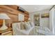 Elegant bedroom with wooden accent wall, modern amenities, and ensuite bathroom at 422 Burns Ct, Sarasota, FL 34236