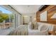 Stylish bedroom with wood paneling, modern decor, and a walkout to a private patio at 422 Burns Ct, Sarasota, FL 34236