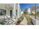 Elegant white stucco home with an arched entryway, complemented by vibrant landscaping and a blue door at 422 Burns Ct, Sarasota, FL 34236