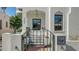 Welcoming entrance with gated stairs, a black-framed door, and charming wall mounted mailbox at 422 Burns Ct, Sarasota, FL 34236