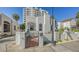 Charming white stucco home with a gated entrance, a brick pathway, and lush landscaping at 422 Burns Ct, Sarasota, FL 34236