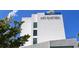A modern hotel exterior featuring minimalist design and the 'ART OVATION' signage at 422 Burns Ct, Sarasota, FL 34236