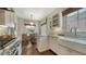 Bright kitchen with white cabinets, stainless steel appliances, and a view to the breakfast nook and window at 422 Burns Ct, Sarasota, FL 34236
