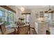 Charming breakfast nook featuring a glass table and white cabinetry with bright natural lighting at 422 Burns Ct, Sarasota, FL 34236