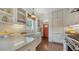 Bright kitchen with white cabinets, stainless steel appliances, farmhouse sink and a view of the red back door at 422 Burns Ct, Sarasota, FL 34236
