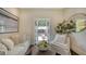 Cozy living room with comfortable seating, a center table, and a view to the outside terrace at 422 Burns Ct, Sarasota, FL 34236
