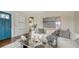 Stylish living room with a bright blue entryway door and elegant modern furnishings at 422 Burns Ct, Sarasota, FL 34236