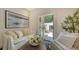 Bright living room with comfortable sofas, a view of the outdoor patio, and stylish decor at 422 Burns Ct, Sarasota, FL 34236