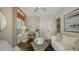 Comfortable living room with hardwood floors, a modern desk, and a stylish seating area at 422 Burns Ct, Sarasota, FL 34236