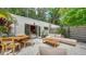 Beautiful outdoor patio with a dining table, lounge seating, and lush landscaping, ideal for outdoor living at 422 Burns Ct, Sarasota, FL 34236