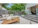 Inviting outdoor patio with stone floors, lounge seating, and a modern coffee table, perfect for entertaining at 422 Burns Ct, Sarasota, FL 34236