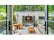 Charming outdoor patio with dining area, lounge seating, and a view into the suite at 422 Burns Ct, Sarasota, FL 34236