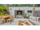 Landscaped outdoor patio features dining, lounging, and a view to the well appointed guest suite at 422 Burns Ct, Sarasota, FL 34236