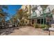 Outdoor patio area with tables, chairs, heaters, and lush greenery, creating an inviting atmosphere at 422 Burns Ct, Sarasota, FL 34236