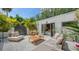 Outdoor patio featuring a dining area, lounge seating, and landscaped surroundings at 422 Burns Ct, Sarasota, FL 34236