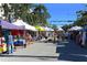 A vibrant street fair with vendors and shoppers enjoying a beautiful day at 422 Burns Ct, Sarasota, FL 34236