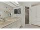Bright bathroom with a dual sink vanity, skylight, and a walk-in shower at 5008 30Th Street E Ct, Bradenton, FL 34203