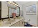 Bathroom with a dual sink vanity, decorative lighting, and a shower at 5008 30Th Street E Ct, Bradenton, FL 34203