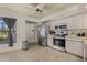 Efficient kitchen with stainless steel appliances, light neutral cabinets, and durable tile flooring at 5008 30Th Street E Ct, Bradenton, FL 34203