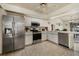 Bright kitchen with stainless steel appliances, tile floors, and ample counter space at 5008 30Th Street E Ct, Bradenton, FL 34203