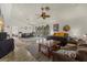 Open-concept room featuring a ceiling fan, slider door access to lanai, and neutral walls and flooring at 5008 30Th Street E Ct, Bradenton, FL 34203