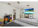 Bright main bedroom with a large television, organized storage, and doorway to the kitchen at 5008 30Th Street E Ct, Bradenton, FL 34203