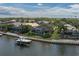Aerial view of waterfront homes each with a boat dock, screened pool, and lush landscaping at 5040 Lake Overlook Ave, Bradenton, FL 34208