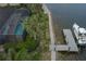 Aerial view of a waterfront property with a screened pool, a dock and lush landscaping at 5040 Lake Overlook Ave, Bradenton, FL 34208