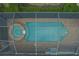 Aerial view of the screened in-ground pool and hot tub with brick paver patio at 5040 Lake Overlook Ave, Bradenton, FL 34208
