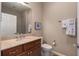 Bathroom featuring vanity with granite countertop, matching framed mirror, toilet, and tiled walk-in shower at 5040 Lake Overlook Ave, Bradenton, FL 34208