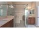 The tiled bathroom has dual vanities and a large glass shower with a built in bench, and a grab bar for safety at 5040 Lake Overlook Ave, Bradenton, FL 34208