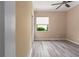 Bedroom showing hardwood floors, neutral walls, ceiling fan, and a window to provide light at 5040 Lake Overlook Ave, Bradenton, FL 34208