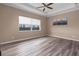 The bedroom features a tray ceiling, a ceiling fan, wood floors and a large window to let in lots of natural light at 5040 Lake Overlook Ave, Bradenton, FL 34208