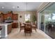 Cozy dining area adjacent to the kitchen features a wood table and chairs, a plant, and sliding glass doors to the screened patio at 5040 Lake Overlook Ave, Bradenton, FL 34208
