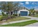 Charming home exterior featuring a well-manicured lawn, lush landscaping, and a brick-paved driveway at 5040 Lake Overlook Ave, Bradenton, FL 34208