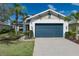 Charming home featuring a spacious garage, and beautifully landscaped yard, and lush palms at 5040 Lake Overlook Ave, Bradenton, FL 34208