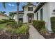 Inviting front entrance surrounded by lush landscaping and a brick walkway at 5040 Lake Overlook Ave, Bradenton, FL 34208