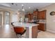 Bright kitchen boasts pendant lighting over an island with countertop seating, stainless appliances, and warm wood cabinetry at 5040 Lake Overlook Ave, Bradenton, FL 34208