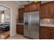 The Kitchen displays stainless steel refrigerator along with wood cabinets and mosaic tile back splash at 5040 Lake Overlook Ave, Bradenton, FL 34208