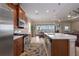 Open kitchen showcases stainless steel appliances, an island, and dining area that opens to an outdoor living space with water views at 5040 Lake Overlook Ave, Bradenton, FL 34208